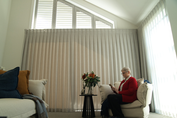 Retiree operating motorised shutter with phone app